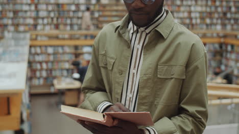 Black-Man-Reading-Book-in-Library